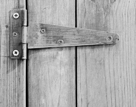 Close up of screwed hinge on wooden door.の写真素材