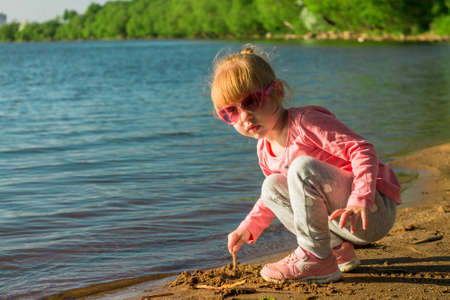 The child runs on the coast in the sand.の写真素材