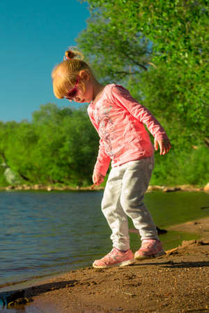 The child runs on the coast in the sand.の写真素材