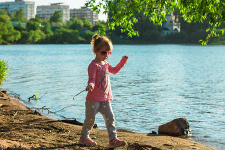 The child runs on the coast in the sand.の写真素材