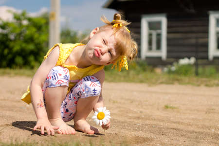 Little girl is twisted, Funny face, Duck smile, Lips bowの写真素材