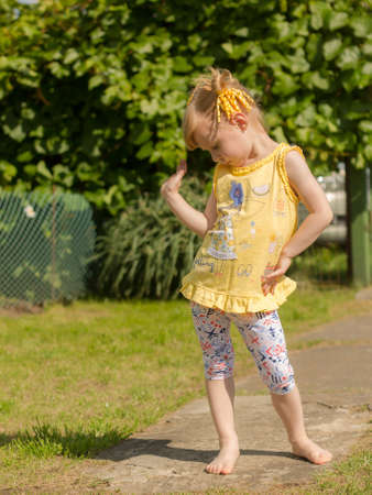 Girl dancing in nature. Pose in the dance.の写真素材