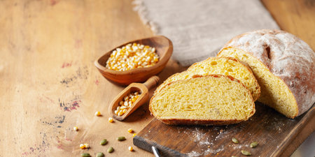 Fresh cornbread and corn grains on the table.