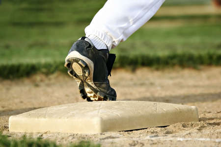 young player foot on baseの写真素材