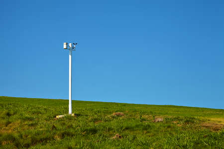 Anemometer in the park against the blue sky.
