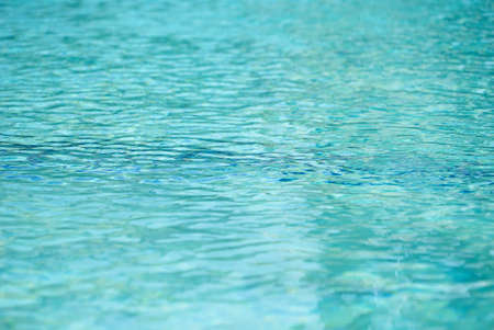 Blue swimming pool rippled water detail. Summer day.の写真素材