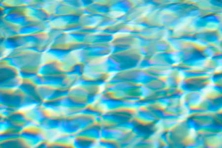 Blue swimming pool rippled water detail. Summer day.