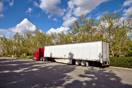 Truck on road with white blank container, blue sky, cargo transportation concept.の写真素材