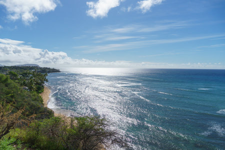 A breathtaking view of the ocean from a sunny cliff edgeの写真素材
