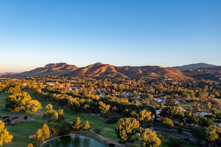 Aerial view of a stunning lake, surrounded by trees and mountainsの写真素材