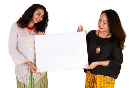 2 Malaysian ladies in traditional dress with blank boardの写真素材