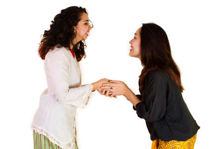 2 Malaysian ladies in traditional dress shaking handsの写真素材
