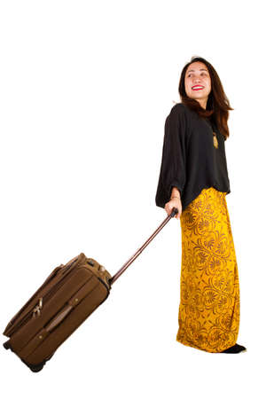 Malaysian lady in traditional dress pulling luggageの写真素材