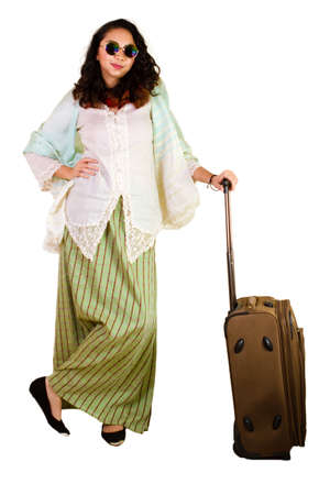 Malaysian lady in traditional dress with luggageの写真素材