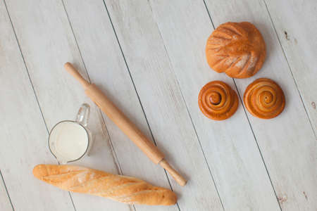 Photo shoot for little cook. Bread and bagels on wooden background.の写真素材