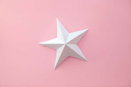 Handmade paper art and cut white star on pink background.の写真素材