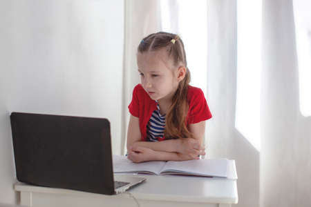 7 year old girl studying online. Webinar. Education at home.の写真素材
