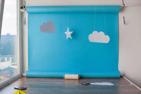Paper background for birthday baby photoshoot. Blue sky and handmade paper cutting stars.
