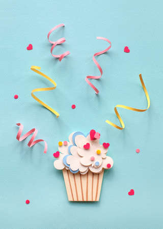 Handmade paper art and cutout cupcake on blue background. With colorful sprinkles. Cartoon style.の写真素材