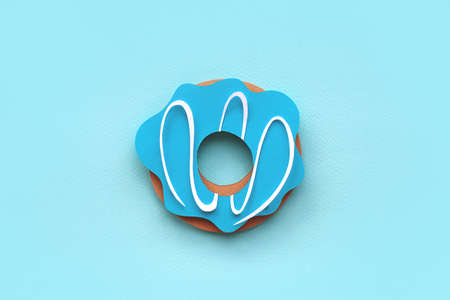 Colorful paper cutout donut on blue background. Colorful sprinkling. Handmade art work for your...