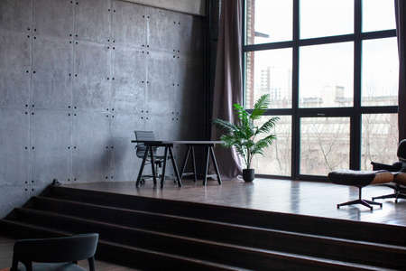 desk in the office. Tropical flower in a pot. Home interior or office in modern style.の写真素材