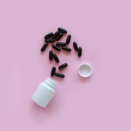 White pill packaging on pink background. Tablets. Close-up.の写真素材
