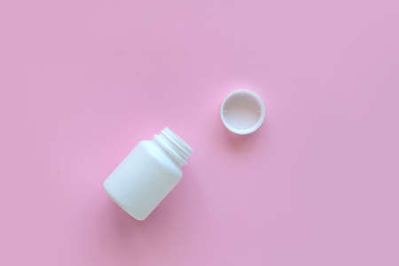 White pill packaging on pink background. Tablets. Close-up.