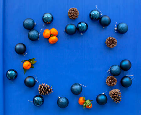 Christmas balls, layout for the New Year and Christmas. Tangerines, pine cones and brown paper. Flat...