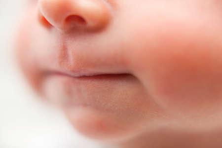 Newborn baby lips. Close up. Face of baby boy. Blurred.