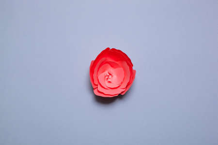 Handmade paper art and cutout flower on blue background.の写真素材