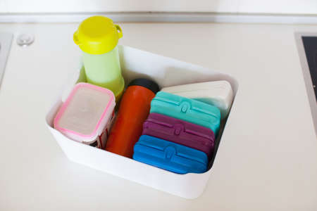 Storage in the kitchen. Towel organization in white basket.の写真素材