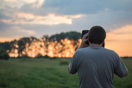 Waiting to take a shot on film of the golden hourの写真素材