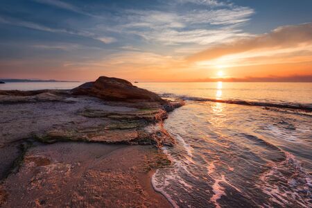 Seascape during sunrise. Beautiful natural seascape. Sea sunrise at the Black Sea coast. Magnificent sunrise with clouds and fire sun in the middle of December.Ravda, Bulgariaの写真素材