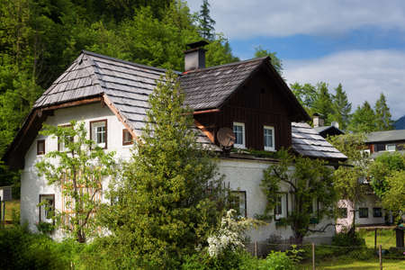 Typical Austrian Alpine house with bright flowers, Hallstatt, Austria, Europeのeditorial素材
