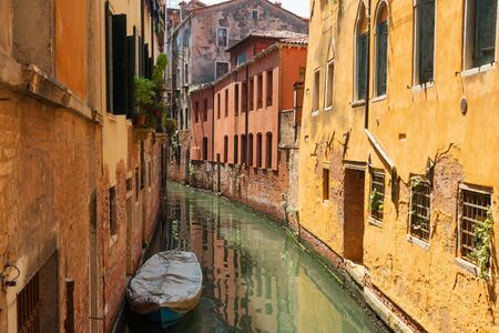 VENICE, ITALY MAY 23, 2017: Traditional narrow canal street with gondolas and old houses in Venice, Italy. Architecture and landmarks of Venice. Beautiful Venice postcard.の写真素材