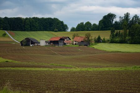 Rural alpine landscape with slovenian village in valley near Bled lake at spring sunny day. Slovenia.の写真素材