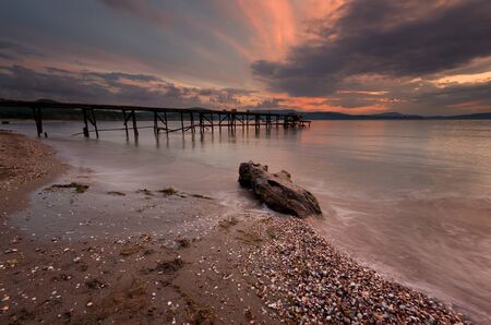Seascape during sunset. Beautiful natural seascape. Sea sunset at the Black Sea coast. Magnificent sunset with clouds and fire sun in the middle of July.の写真素材