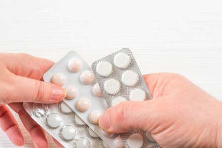 Close-up of a doctor's hand giving a blister card with capsules to the patientの写真素材