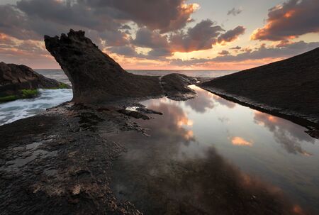 Seascape during sunrise. Beautiful natural seascape. Sea sunrise at the Black Sea coast. Magnificent sunrise with clouds and fire sun. Rezovo, Bulgariaの写真素材