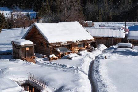 Winter forest scene. Small house at the mountain in a sunny winter day. Snowy fairytale in Bulgaria.の写真素材