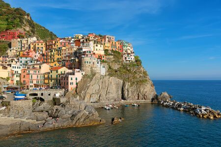 Magnificent daily view of the Manarola village in a sunny summer day. Manarola is one of the five famous villages in Cinque Terre (Five lands) National Park. Liguria, Italy, Europeの写真素材