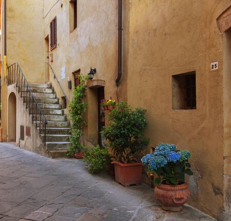 Traditional facade of Italian house in the small magical and old village of Pienza, Val D'Orcia Tuscany, Italyの写真素材