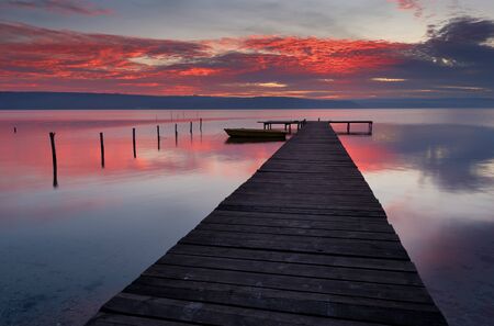 Seascape during sunset. Beautiful natural seascape, blue hour. Sea sunset at the Black sea coast near Varna, Bulgaria. Magnificent sunset with clouds and bridgeの写真素材