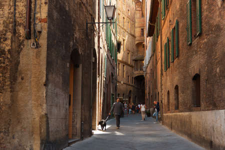 SIENA, ITALY MAY 25, 2017: Beautiful medieval narrow street in the spring. Historic centre of Siena has been declared by UNESCO a World Heritage Site.のeditorial素材