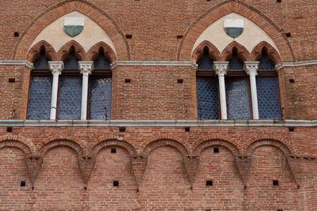 Architectural detail of the Palazzo Pubblico at the Piazza del Campo in Siena, Italy, Europeのeditorial素材