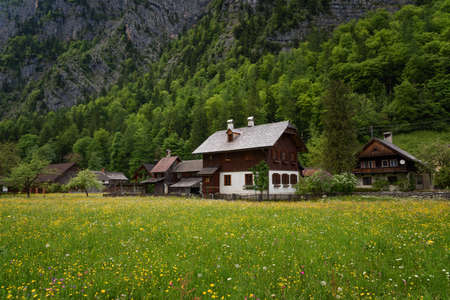 Typical Austrian Alpine houses with bright flowers, Hallstatt, Austria, Europeのeditorial素材