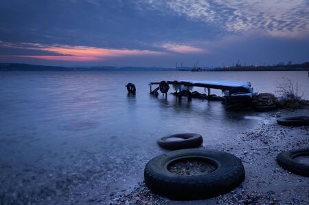 Seascape during sunset. Beautiful natural seascape, blue hour. Sea sunset at a lake coast near Varna, Bulgaria. Magnificent sunset with clouds in the middle of February.の写真素材
