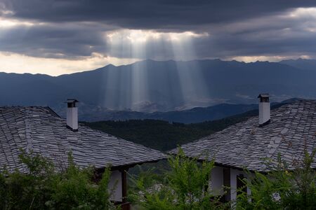 Sun rays between the clouds after sunset at Leshten village, Bulgariaの写真素材