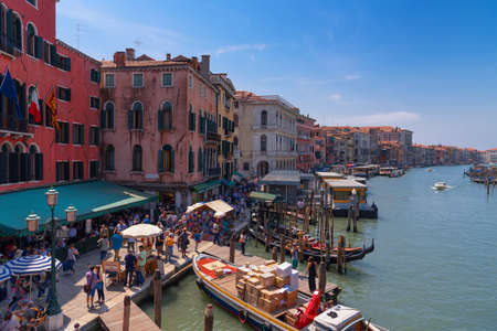 VENICE, ITALY, MAY 23, 2017: Magnificent daily view of Gondola with classical buildings along the famous Grand canal in Venice, Italyの写真素材