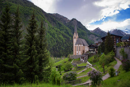 Heiligenblut with St Vincent Church in the background the beautiful Grossglockner. Beautiful sunny summer day in Austria.の写真素材
